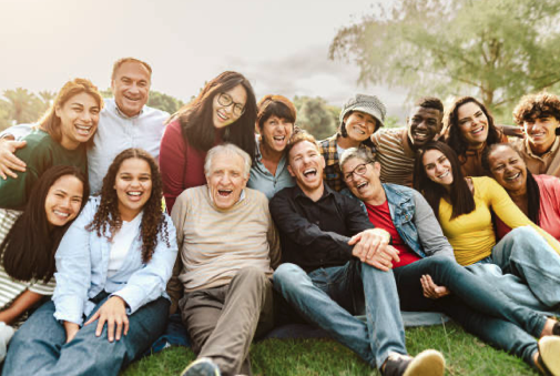 carers support group with group of people sitting on grass