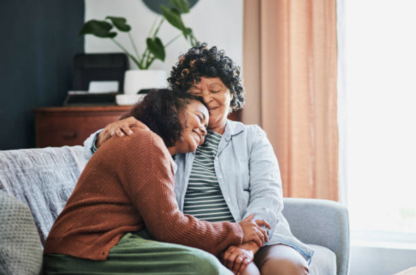 Mother and Daughter hugging on sofa