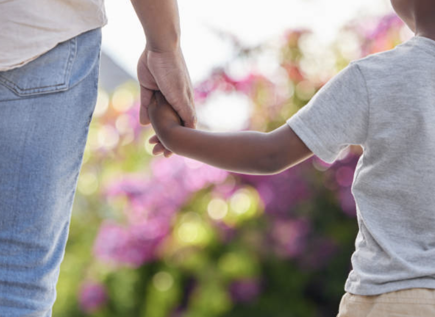 Woman and son walking hand in hand