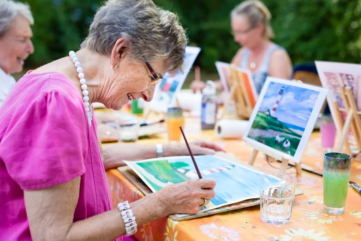 elderly lady painting at a carers support group